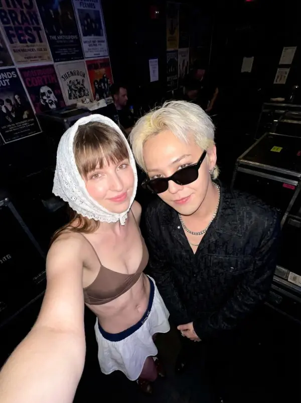 Same user shown in a backstage-style selfie with a music-industry co-star
